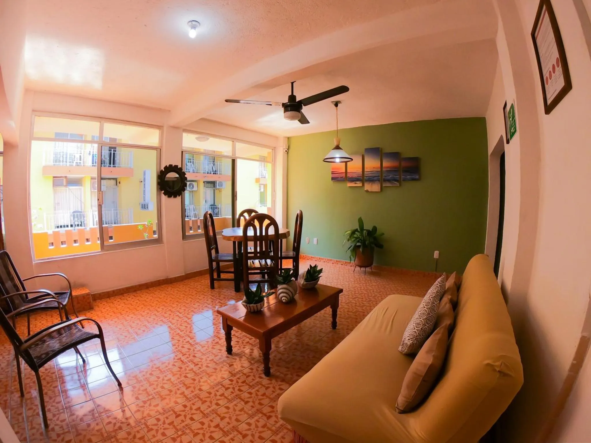 Espace de détente intérieur avec canapés, table basse et décoration murale.