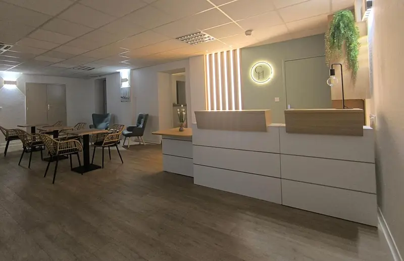 Un comptoir d'accueil moderne avec un espace d'attente lumineux.