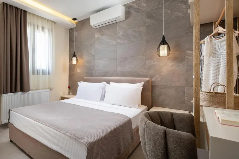Une chambre lumineuse avec un grand lit et un coin salon.