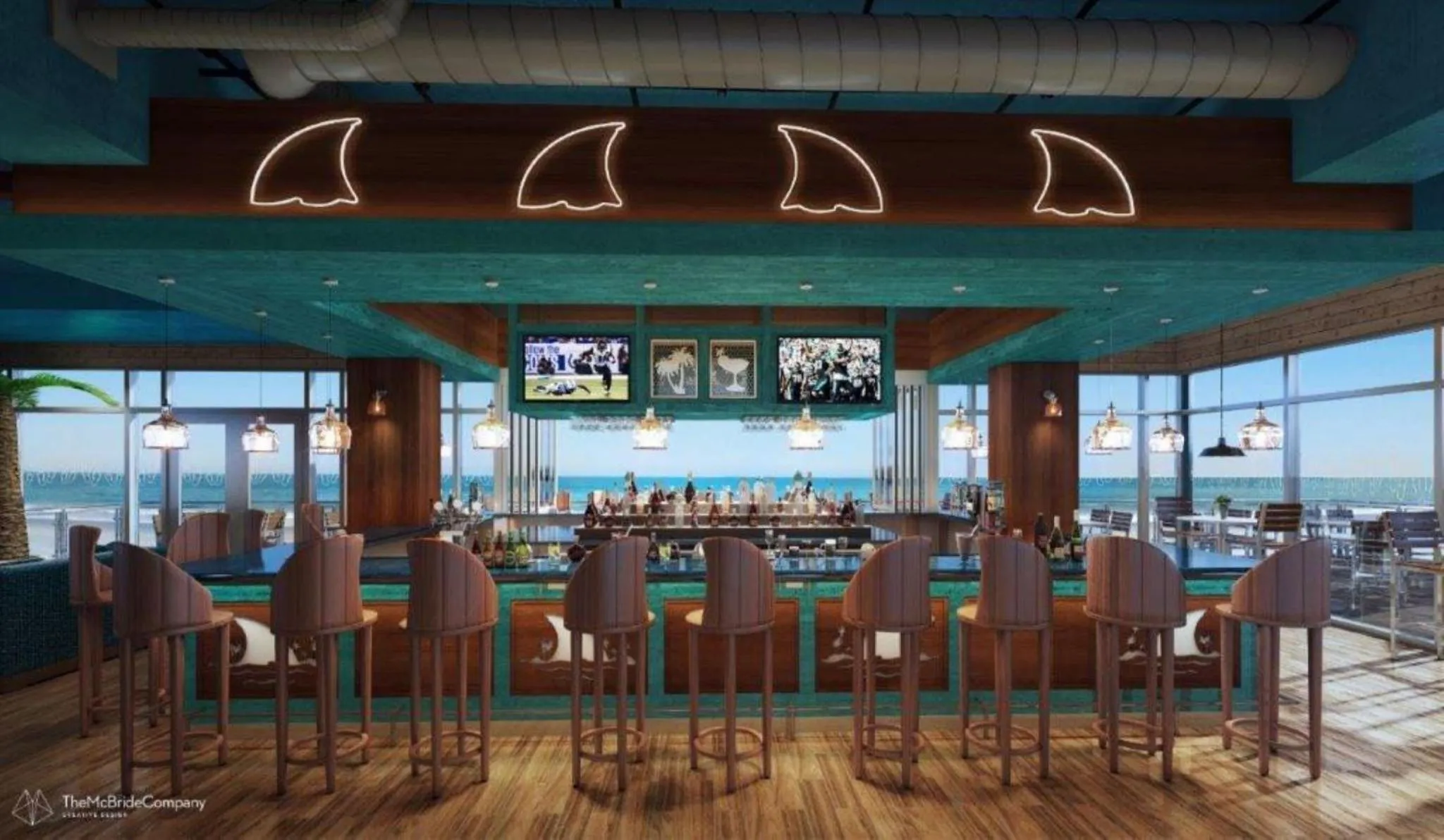 Un long comptoir de bar avec des tabourets, face à une vue sur la mer.
