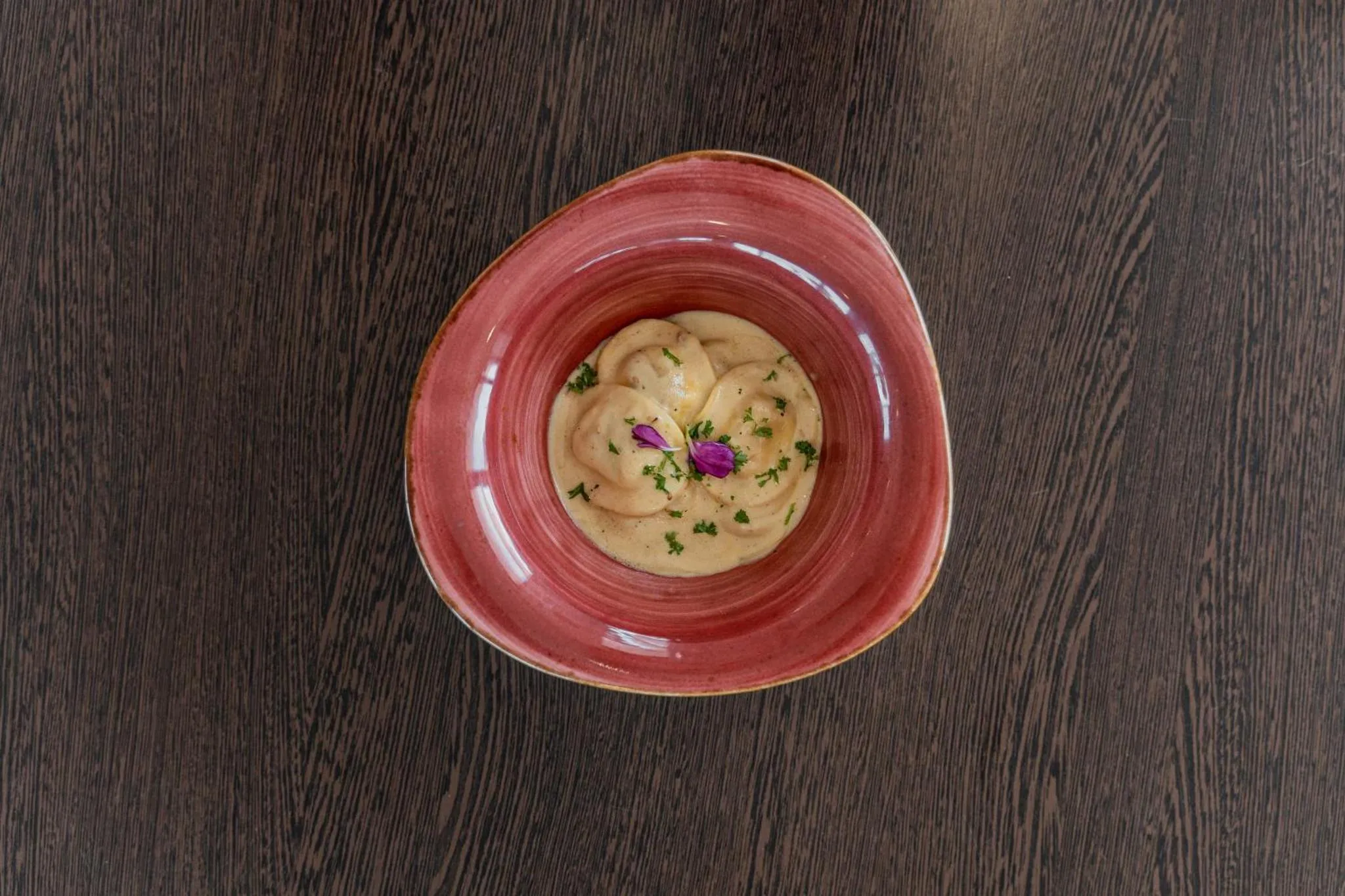 Un plat de champignons à la crème est présenté dans un bol rouge.