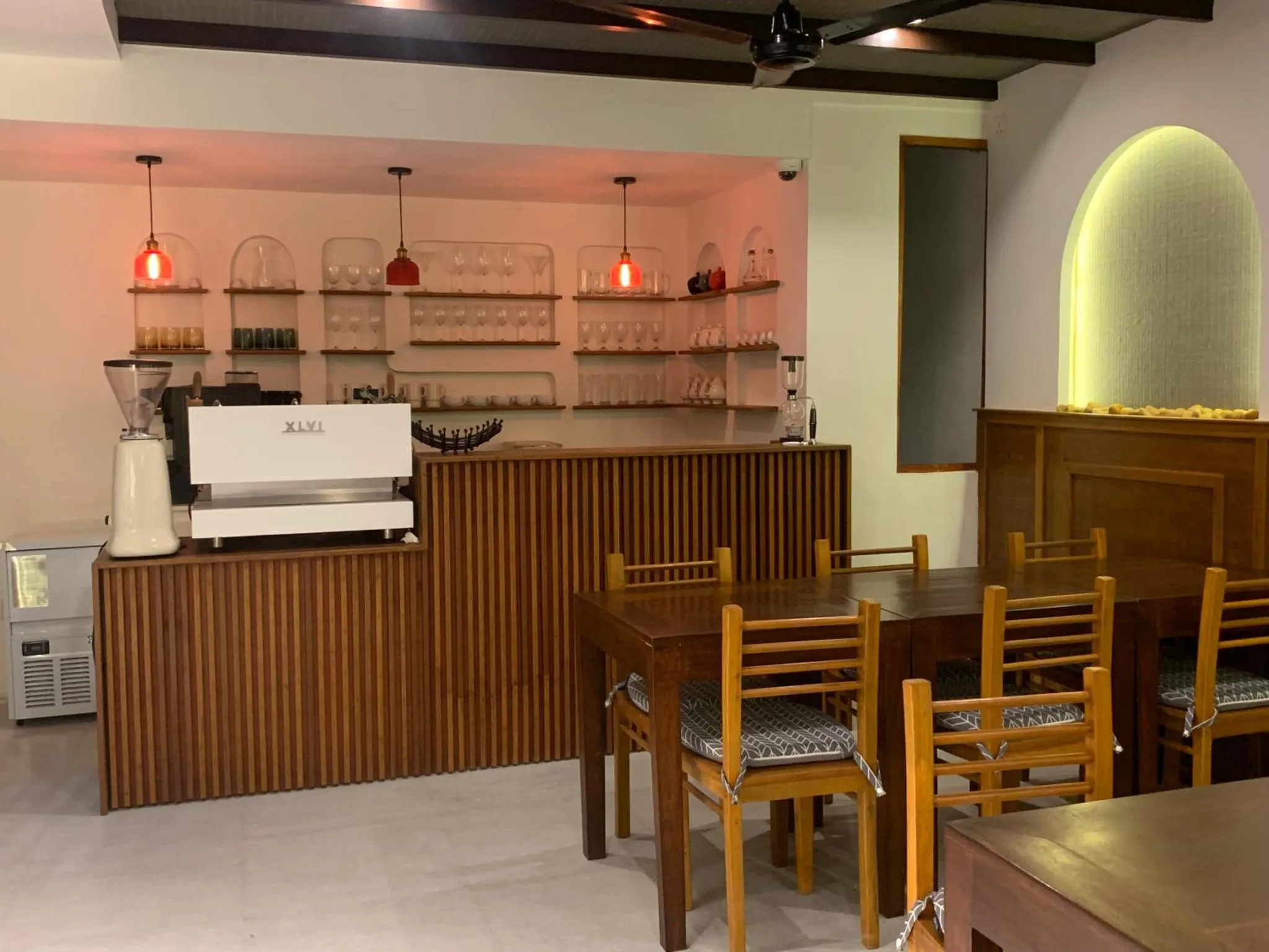 Une salle lumineuse avec un comptoir en bois et des tables à manger.