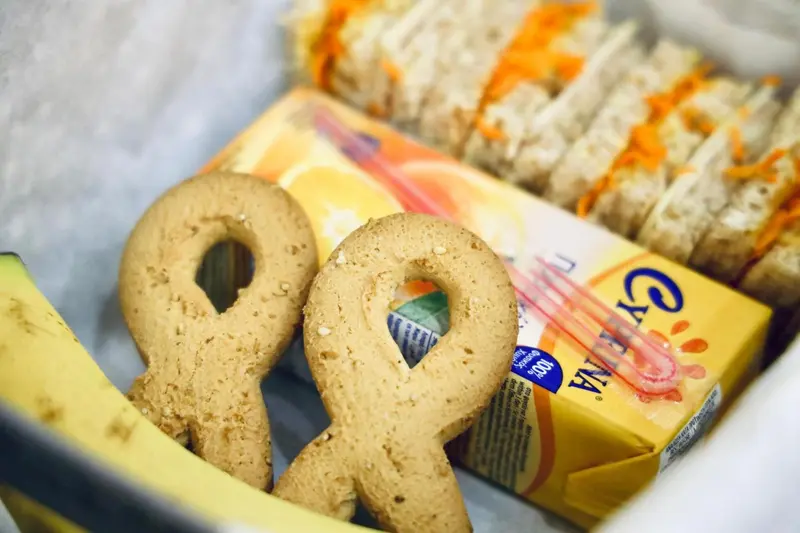 Assortiment de viennoiseries et de sandwichs présentés dans un panier.
