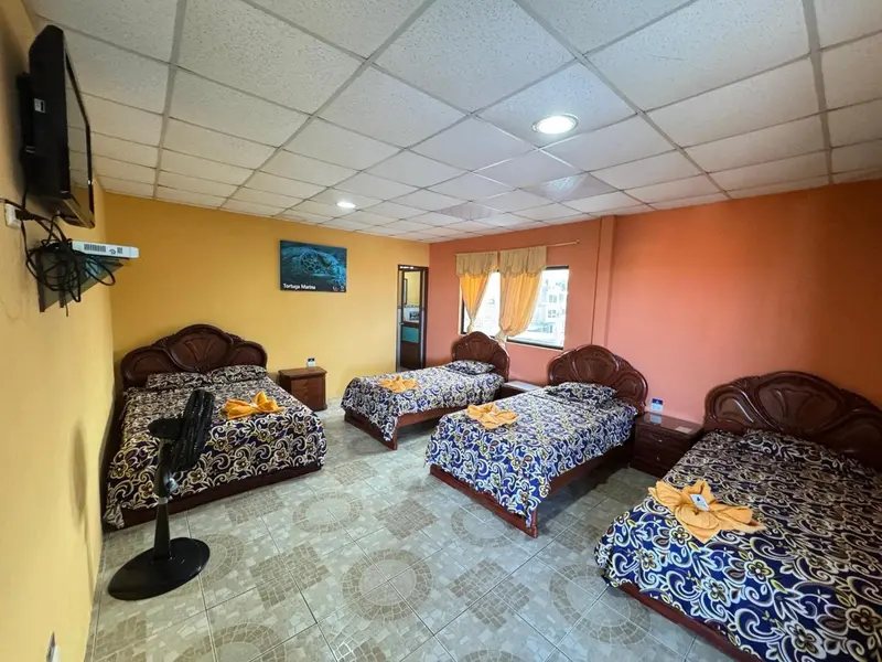 Une chambre avec plusieurs lits décorés de motifs bleus et de fleurs.