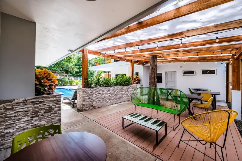 Espace extérieur aménagé avec des meubles colorés et une piscine.