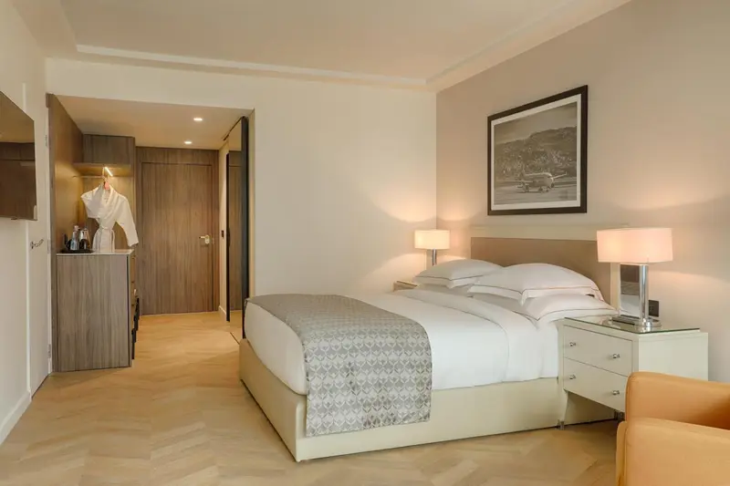 Une chambre lumineuse avec un grand lit et un espace détente.