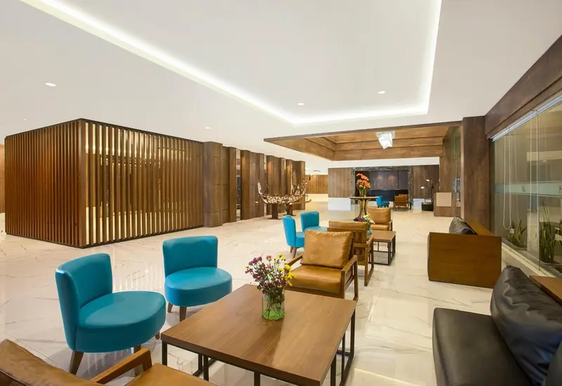 Espace de détente intérieur avec canapés et fauteuils.