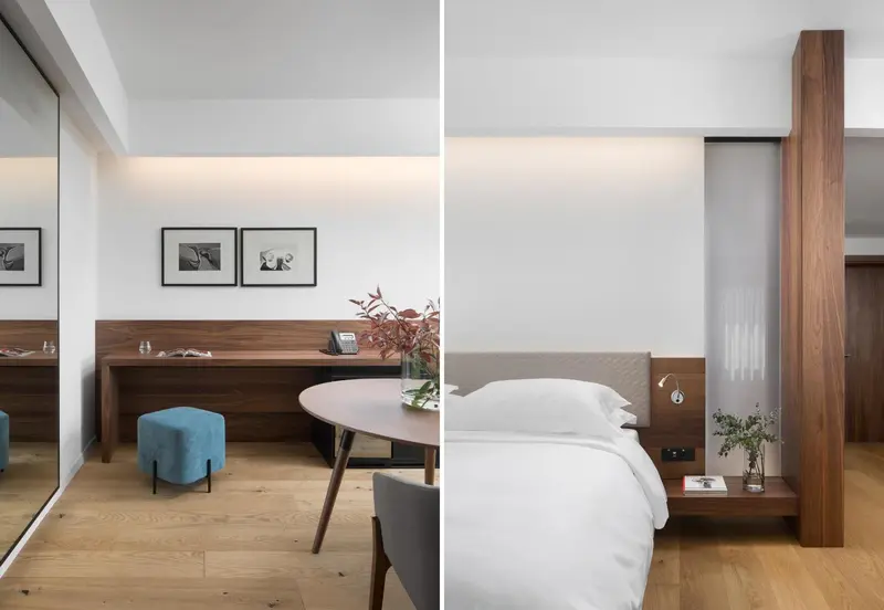 Une chambre lumineuse avec un lit blanc et un bureau en bois.