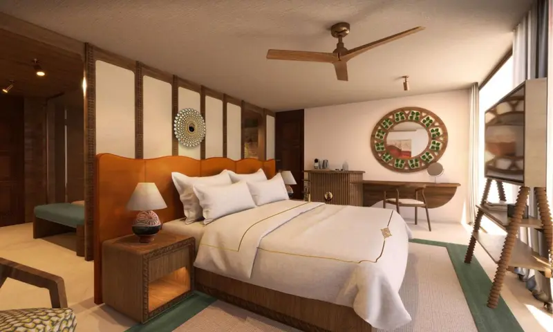 Une chambre lumineuse avec un grand lit et une décoration murale.
