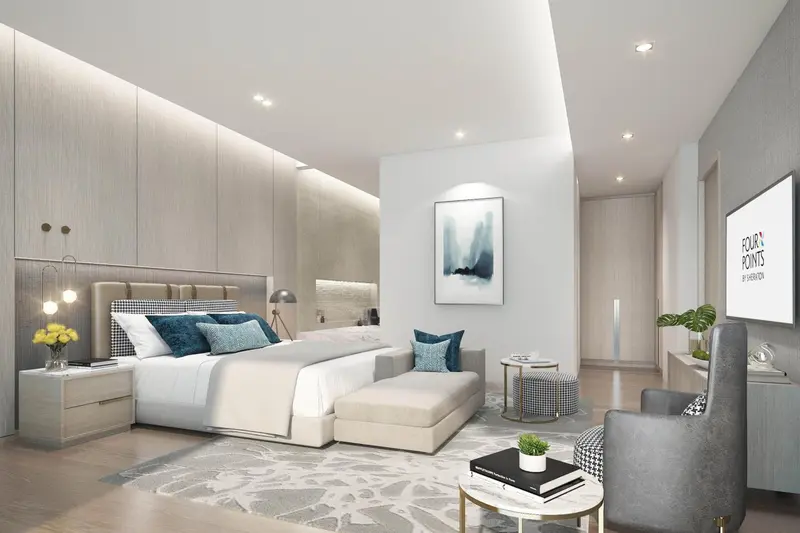 Une chambre lumineuse avec un grand lit et un fauteuil.