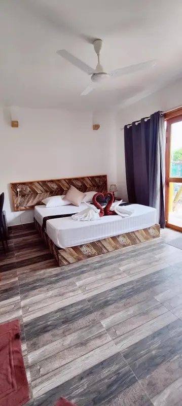 Une chambre lumineuse avec un grand lit décoré de fleurs.