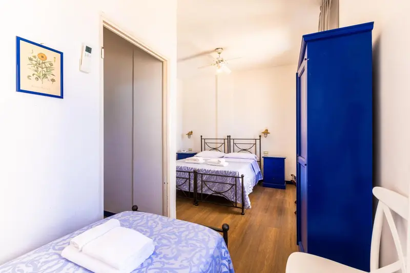 Une chambre lumineuse avec un lit double et un lit simple.