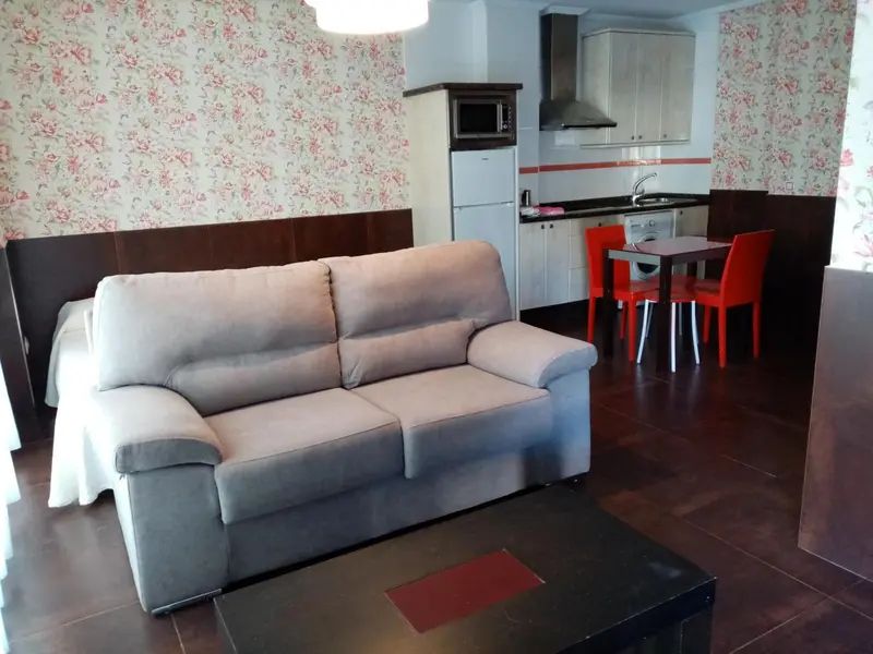 Espace de vie avec canapé et coin repas.