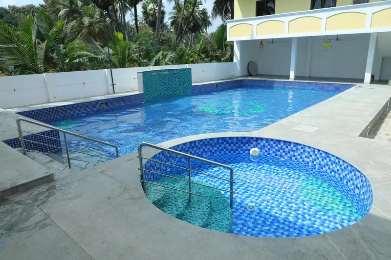 Piscine rectangulaire et jacuzzi attenant dans un espace extérieur aménagé.