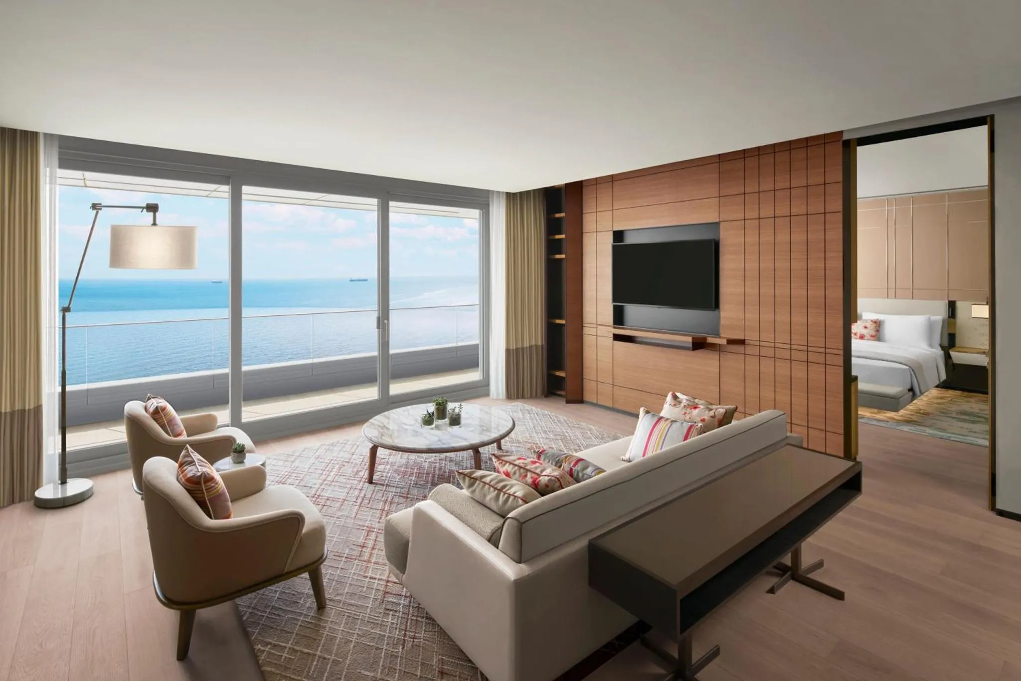 Espace de détente lumineux avec canapés et vue sur la mer.