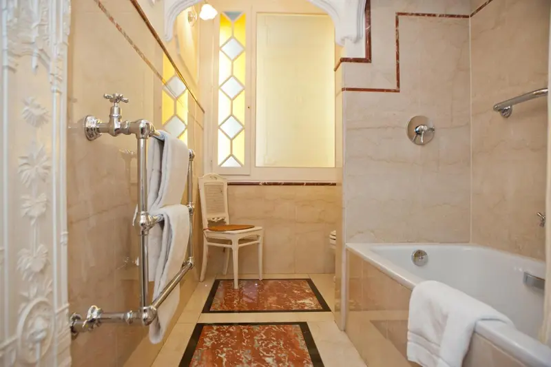 Salle de bain lumineuse avec baignoire et carrelage décoratif.
