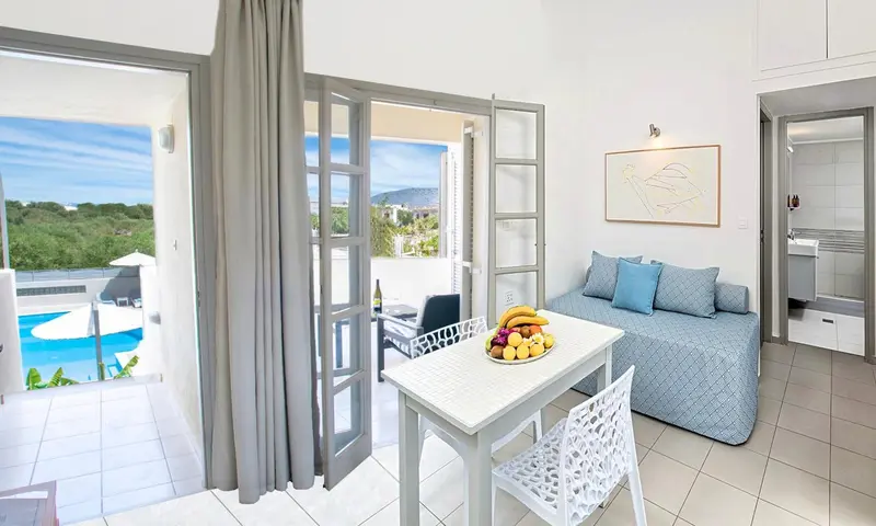 Espace de vie lumineux avec coin repas et vue sur la piscine.