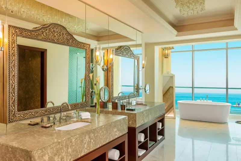 Une salle de bain spacieuse avec une grande baignoire et une vue sur la mer.