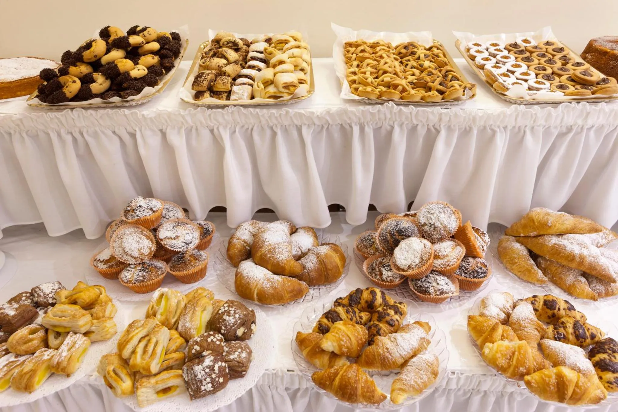 Une table garnie de viennoiseries et de pâtisseries.