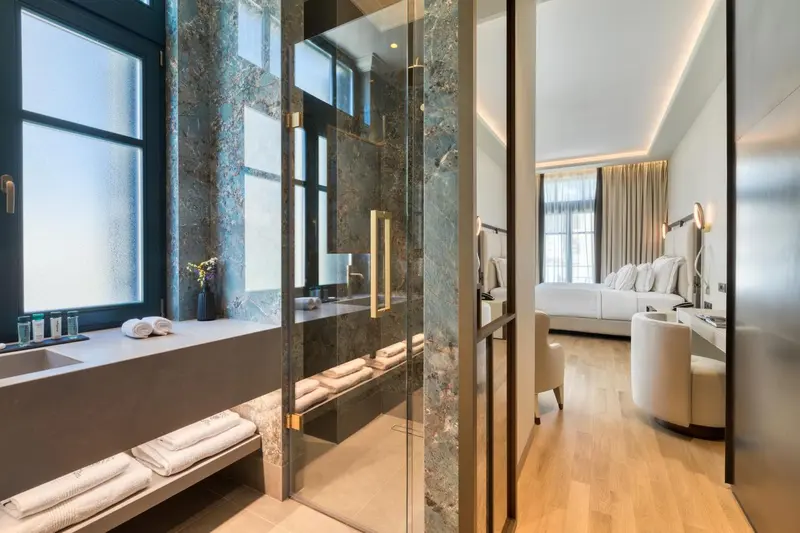 Une salle de bain moderne avec une douche à l'italienne et une chambre à coucher lumineuse.