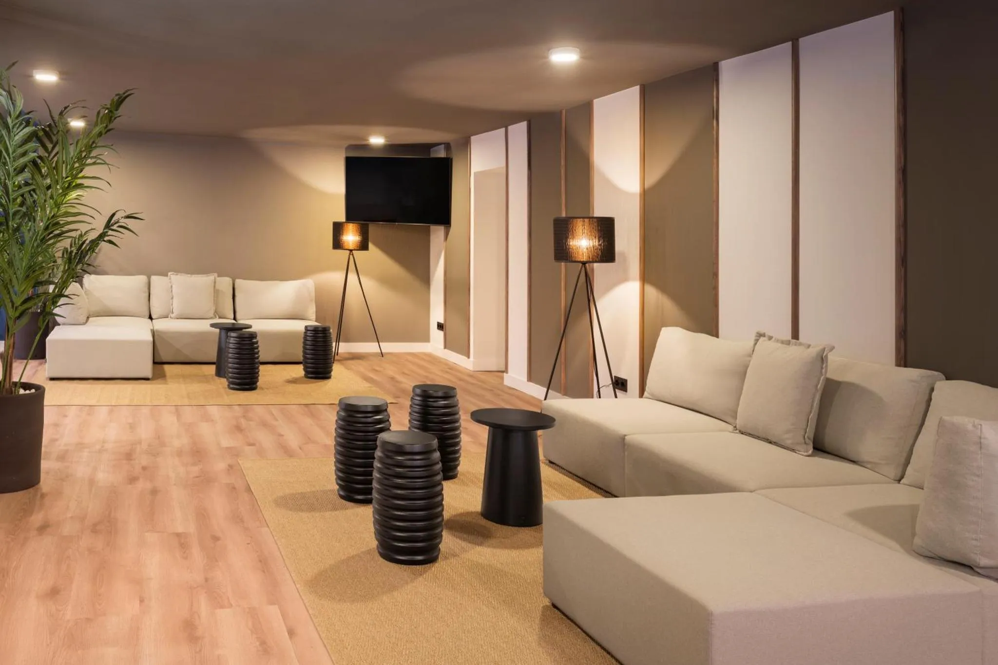 Espace de détente intérieur avec canapés et éclairages design.