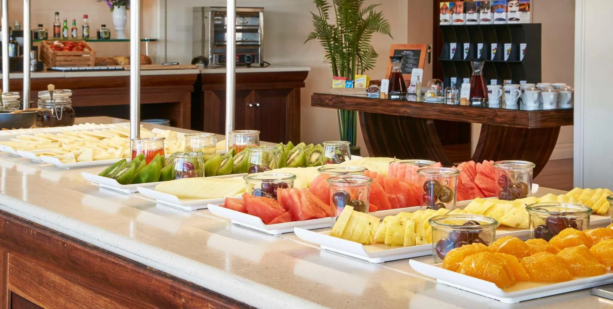 Un buffet propose une variété de fruits frais et de pâtisseries.