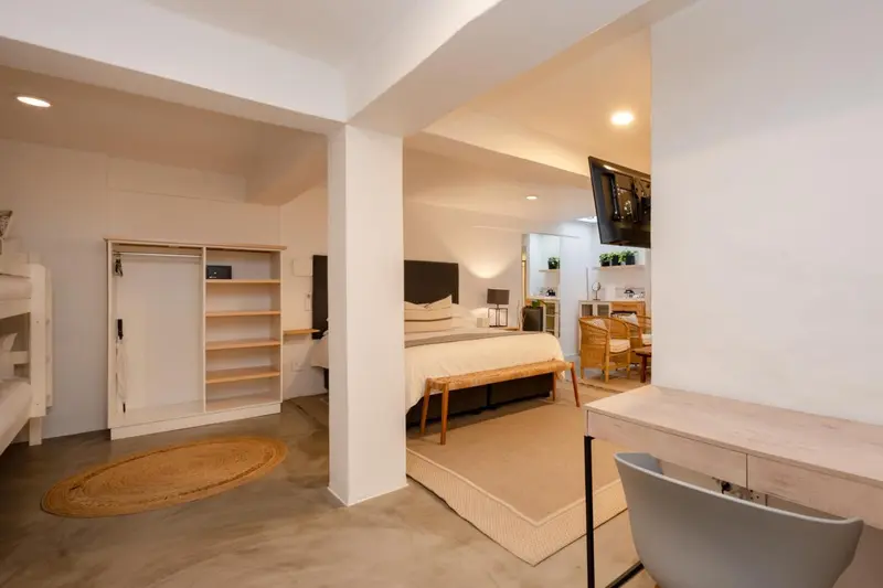 Une chambre lumineuse avec un lit et un espace bureau.