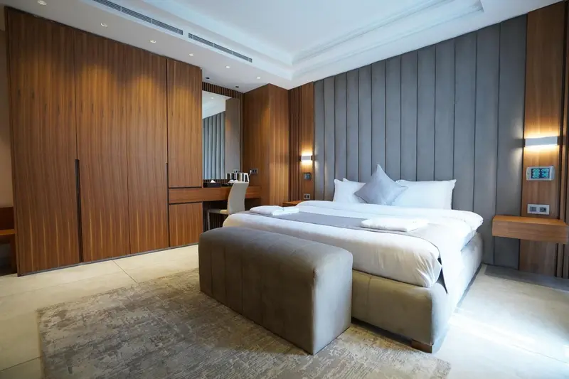 Une chambre moderne avec un grand lit et un mobilier en bois.