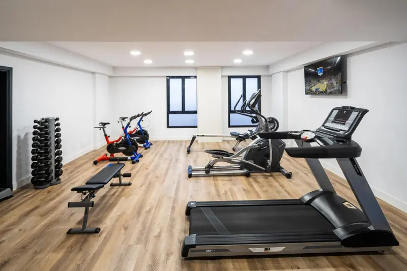 Une salle de sport lumineuse avec divers équipements de fitness.