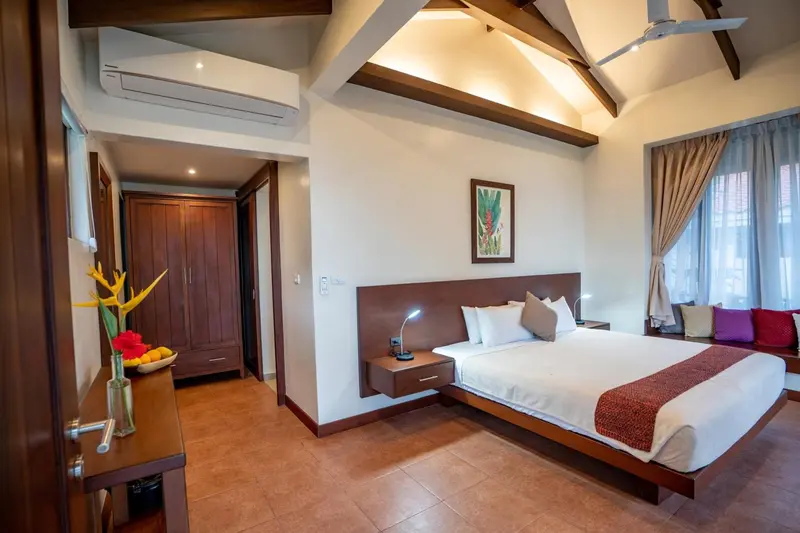 Une chambre lumineuse avec un grand lit et un mobilier en bois.