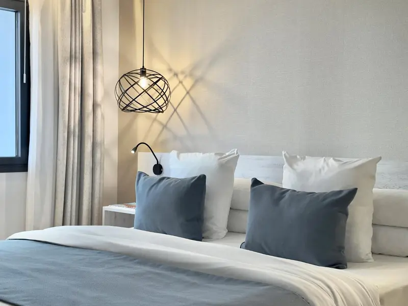 Un lit confortable avec des oreillers moelleux dans une chambre lumineuse.