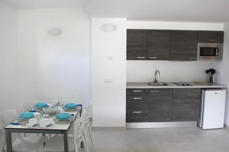 Une cuisine moderne avec une table à manger pour deux personnes.