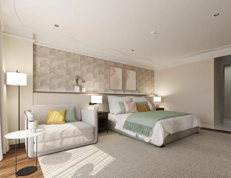 Une chambre lumineuse avec un lit double et un coin salon.