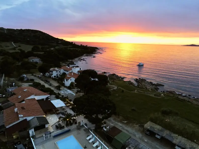 Vue aérienne d'un établissement au bord de mer au coucher du soleil.