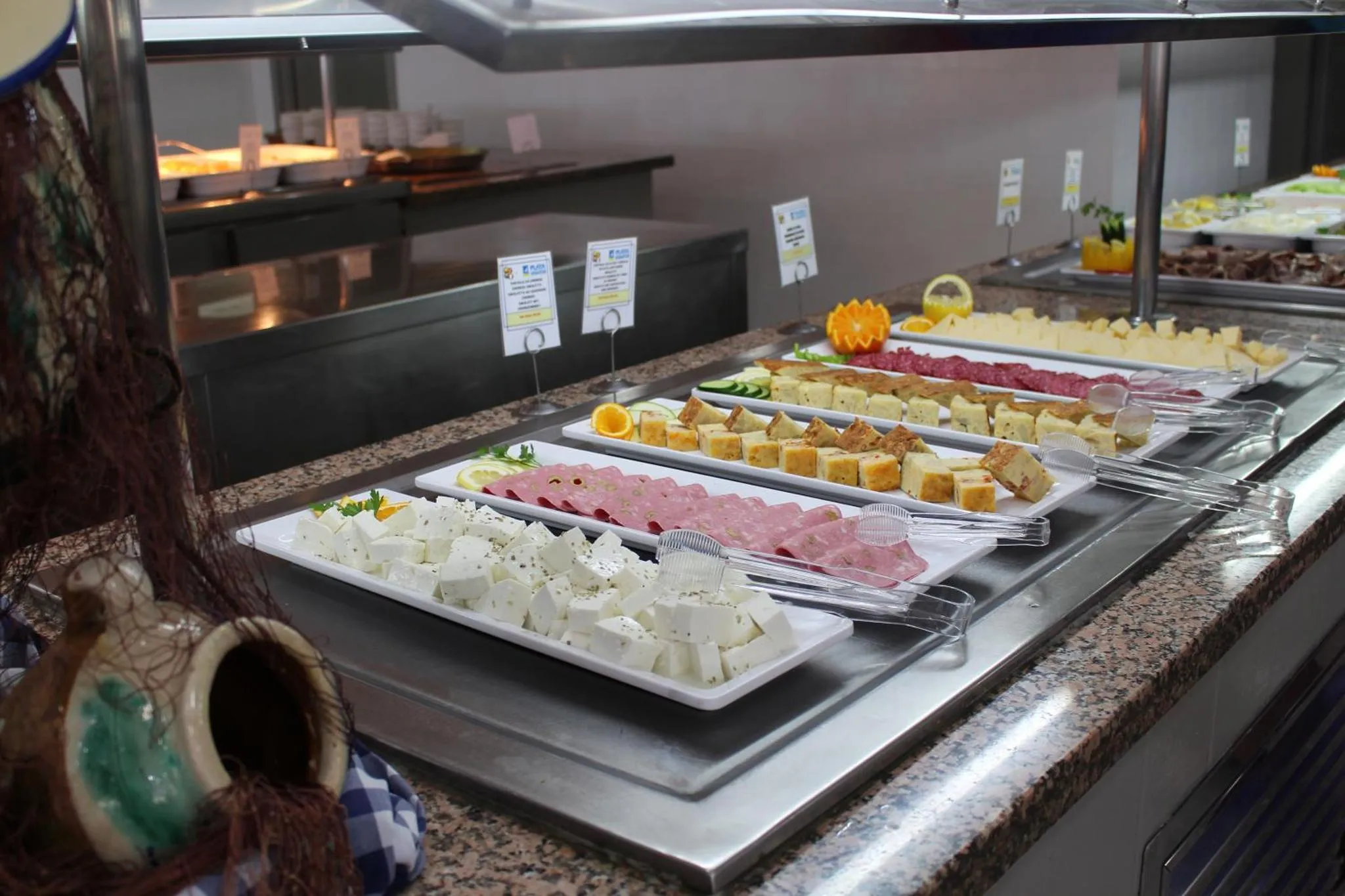 Un buffet propose une variété de charcuteries et de fromages.