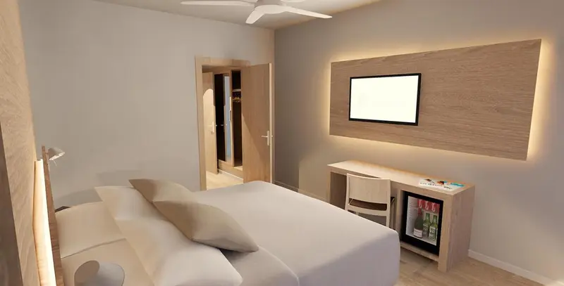 Une chambre lumineuse avec un lit double et un bureau.