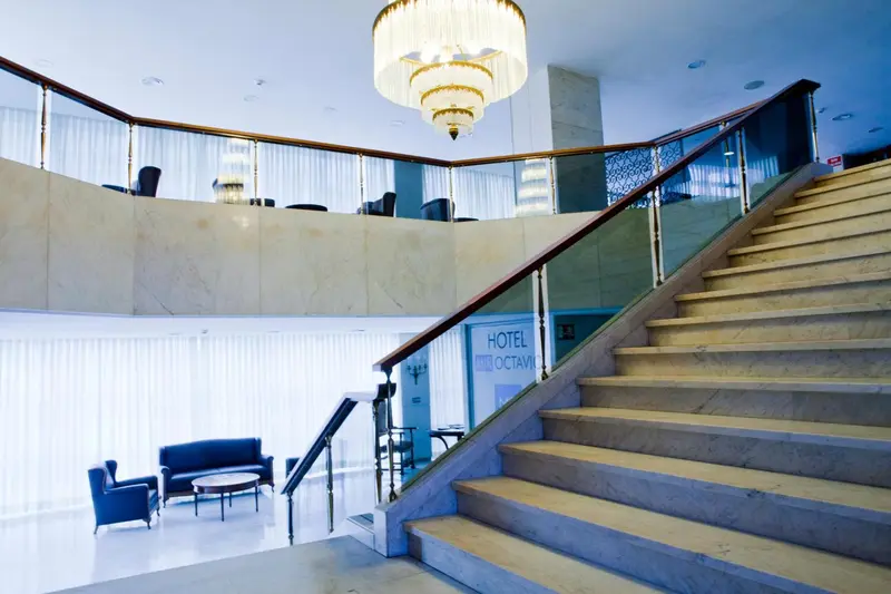 Un escalier en marbre mène à l'étage supérieur d'un hall d'hôtel.
