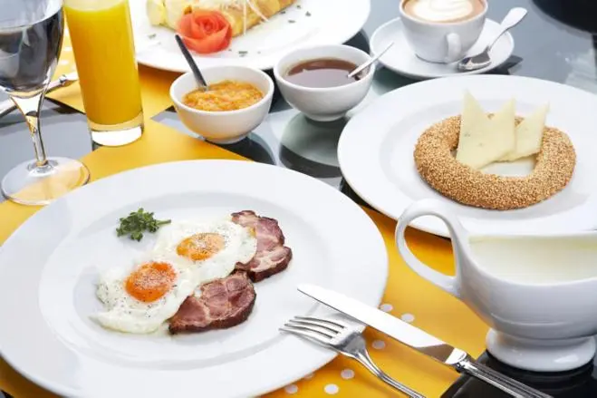 Une table est dressée avec un petit-déjeuner copieux.