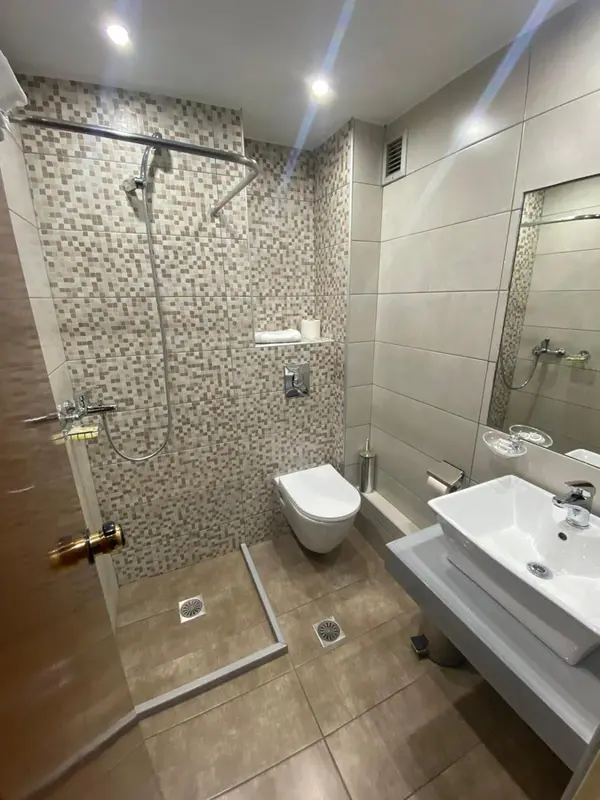 Une salle de bain moderne avec douche à l'italienne et lavabo.