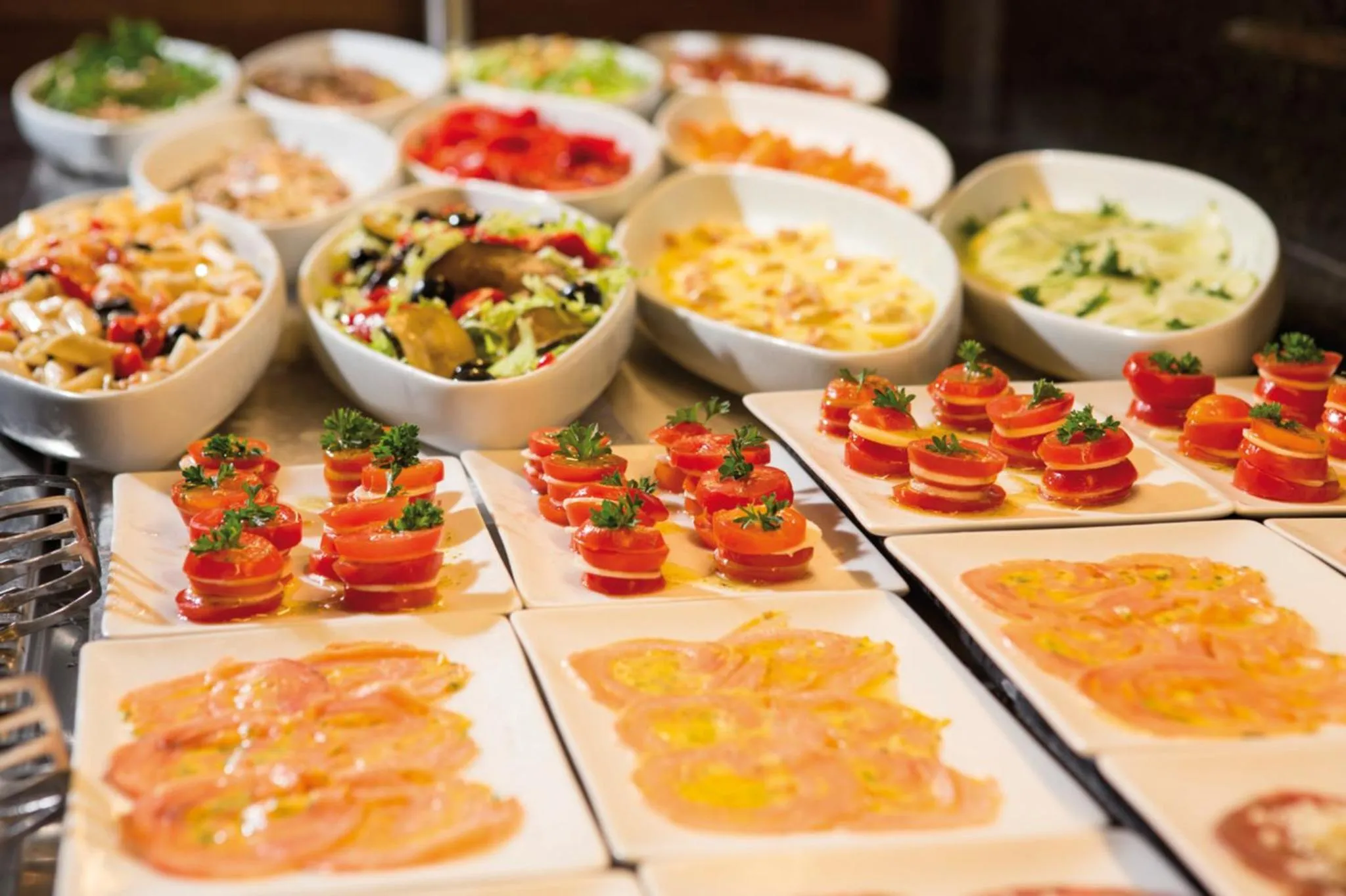 Un buffet propose une variété de salades, de crudités et de plats préparés.