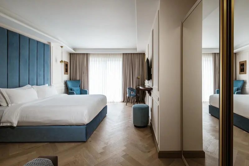 Une chambre lumineuse avec un grand lit et un espace détente.