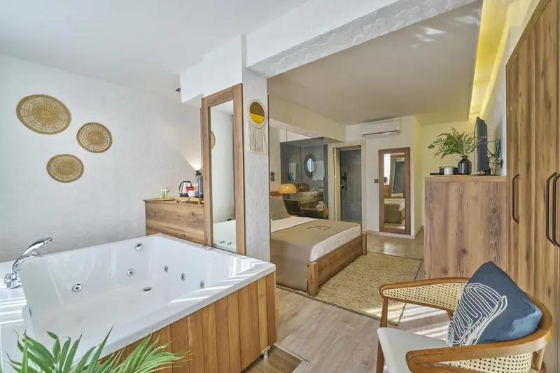 Une chambre lumineuse avec baignoire et espace détente.