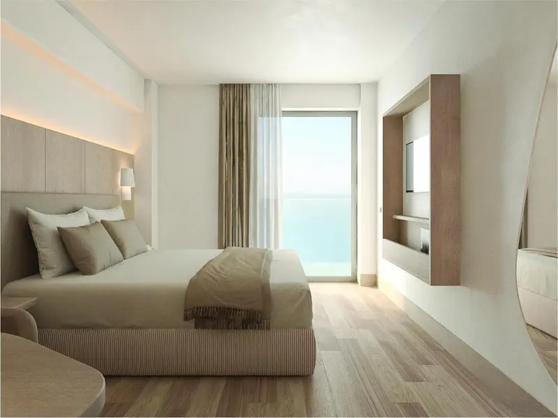 Une chambre lumineuse avec un grand lit et une vue sur la mer.