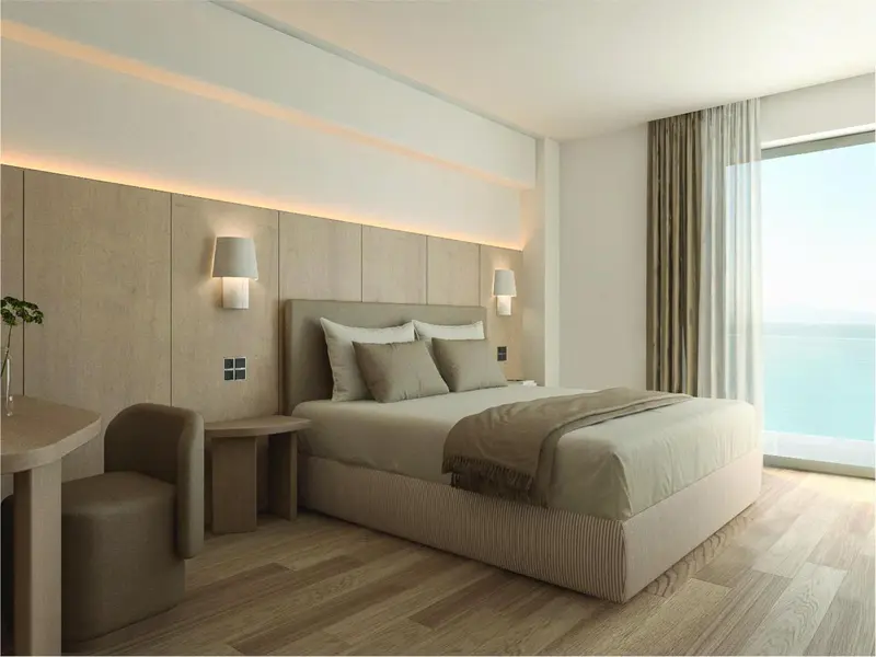 Chambre moderne avec un grand lit et une vue sur la mer.