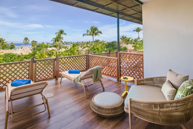 Espace de détente extérieur avec mobilier de jardin et vue sur la végétation.