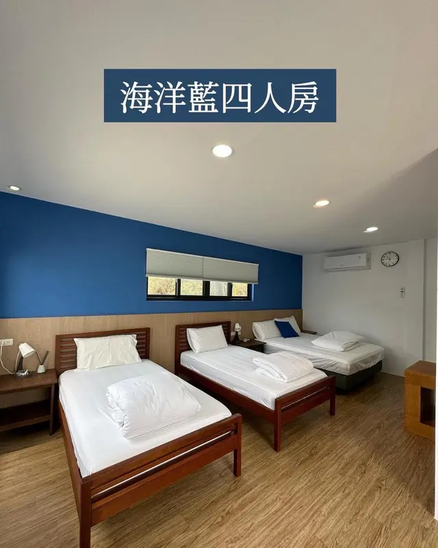 Chambre avec deux lits simples et une fenêtre.