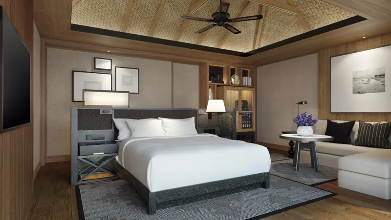 Une chambre spacieuse avec un grand lit et un coin salon.