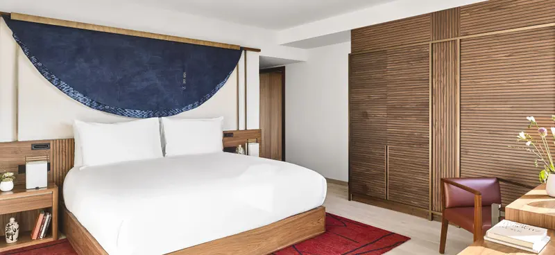 Une chambre lumineuse avec un grand lit et une décoration sobre.