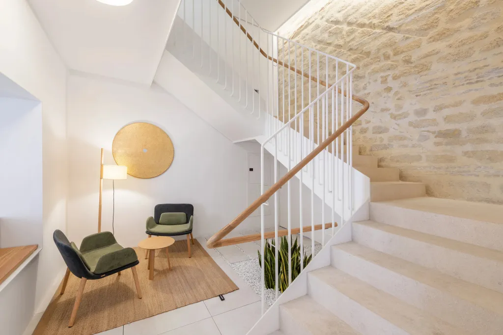Un espace de détente avec des fauteuils et un escalier en colimaçon.