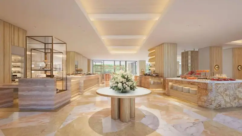 Présentation de plats variés sur un buffet dans une salle lumineuse et moderne.